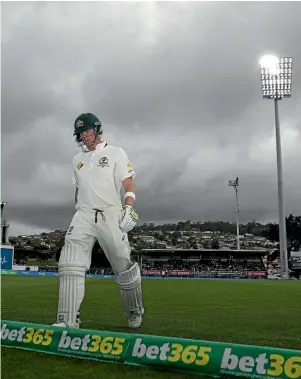  ??  ?? Steve Smith trudges off the field in Hobart at the end of Australia’s first innings yesterday. They scored just 85.