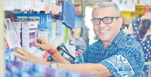  ?? Picture: JOVESA NAISUA ?? Dharmendra Kumar sorts out some of the products at his shop ‘Things n Movies’ in Flagstaff, Suva.