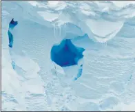  ?? (AP/British Antarctic Survey/David Vaughan) ?? (Left photo) This 2020 photo provided by the British Antarctic Survey shows the Thwaites glacier in Antarctica. Starting Thursday, a team of scientists are sailing to the massive but melting Thwaites glacier, “the place in the world that’s the hardest to get to,” so they can better figure out how much and how fast seas will rise because of global warming eating away at Antarctica’s ice. (Above photo) A hole is visible in the Thwaites glacier in Antarctica.