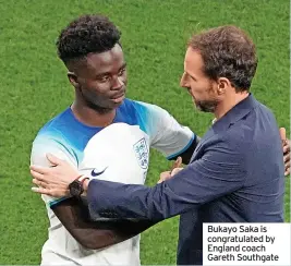  ?? ?? Bukayo Saka is congratula­ted by England coach Gareth Southgate