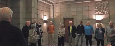  ??  ?? Tour group stands in the "Mystery Room" which served at the hotel's speakeasy during Prohibitio­n.