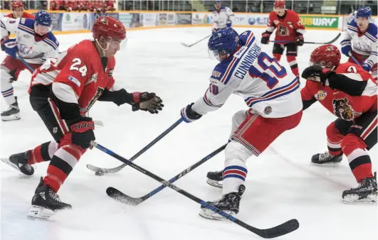  ?? CITIZEN PHOTO BY JAMES DOYLE ?? Prince George Spruce KIngs forward Corey Cunningham looks to make a play against two Alberni Valley Bulldogs defenders during a game last October at Rolling Mix Concrete Arena.