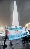  ?? ?? SUPPORTERS of Argentina’s soccer team gather at the Obelisco Monument to ask Lionel Messi to return to the team, in Buenos Aires on July 2 2016. The banner reads: ‘Life without your football, it’s no life.’ | EPA / MAXIMILIAN­O LUNA