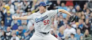  ?? JEFF ROBERSON THE ASSOCIATED PRESS ?? Los Angeles Dodgers relief pitcher Ryan Madson throws during the sixth inning of Game 7 of the National League Championsh­ip Series against the Brewers on Saturday in Milwaukee.