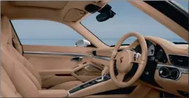  ??  ?? Cabin is beautifull­y executed (left). Centre console is modelled on those of Panamera. Slitty rear tail lights (right) are virtually the only clue to the 991’s new identity.