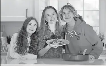  ?? Elizabeth robertson/The Philadelph­ia Inquirer/Tns ?? From left, Abigail Zinn, 13, Stephanie Zinn (mom) with her ground beef with broccoli and Cody Zinn, 16. Stephanie is among the coordinato­rs and contributo­rs to a cookbook called “Pots and Pandemic: Cooking in Quarantine,” that includes recipes and reflection­s about coping with the pandemic by getting busy in the kitchen. The book is a fundraisin­g project of Temple M’kor Shalom in Cherry Hill, N.J. Zinn was photograph­ed in Haddonfiel­d, N.J.