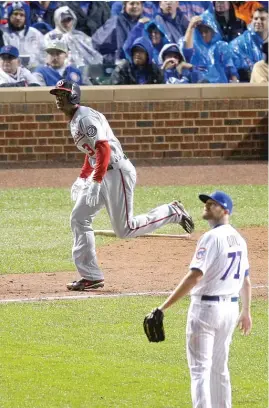  ??  ?? Cubs closer Wade Davis watches Nationals outfielder Michael Taylor’s grand slam land in the basket in the eighth inning Wednesday at Wrigley Field.
| AP