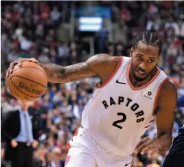  ?? CP PHOTO ?? Toronto Raptors forward Kawhi Leonard drives to the net against during a game against the Dallas Mavericks in Toronto on Friday.