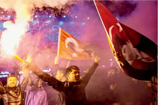  ?? AFP ?? Supporters of the main opposition Republican People’s Party (CHP) wave flags and light up torches to celebrate the local election in Istanbul, Turkey, on Monday. —