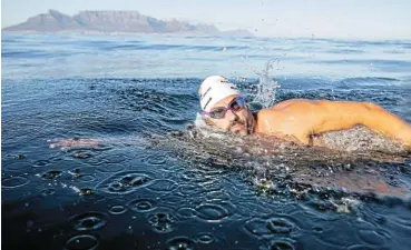  ?? /Caleb Bjergfelt ?? Century swim: Ryan Stramrood during his 100th Robben Island swim in the icy water of the Atlantic Ocean.