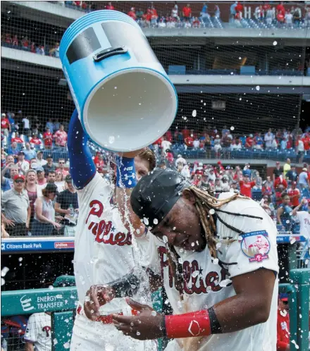  ?? MATT SLOCUM — THE ASSOCIATED PRESS ?? The Phillies’ Maikel Franco, right, is doused by Bryce Harper after Franco hit the game-winning home run during the ninth inning of a baseball game, Sunday in Philadelph­ia.