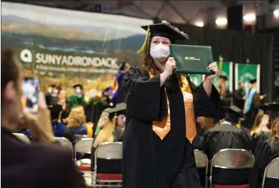  ?? COURTESY OF SUNY ADIRONDACK ?? A graduate proudly holds her diploma at the 2022 SUNY Adirondack Commenceme­nt Ceremony.