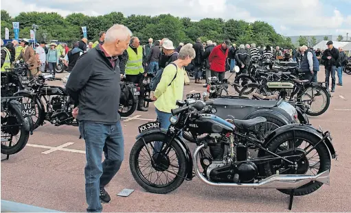  ?? ?? Motorcycle­s and spectators before the start.