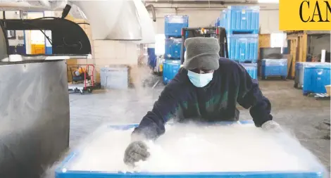  ?? SAUL LOEB/AFP VIA GETTY IMAGES ?? An employee at Capitol Carbonic in Baltimore, Maryland, makes dry ice pellets, which are needed for transporti­ng Pfizer's new COVID vaccine.