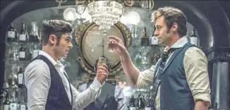  ??  ?? Zac Efron, left, and Hugh Jackman in “The Greatest Showman.”