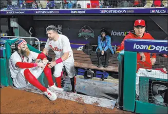  ?? Matt Slocum The Associated Press ?? Phillies outfielder Brandon Marsh, left, and DH Kyle Schwarber sit stunned after the team lost two home games with a chance to clinch.