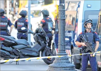  ?? AFP ?? Police cordon off the busy street in Barcelona following the terrorist attack.