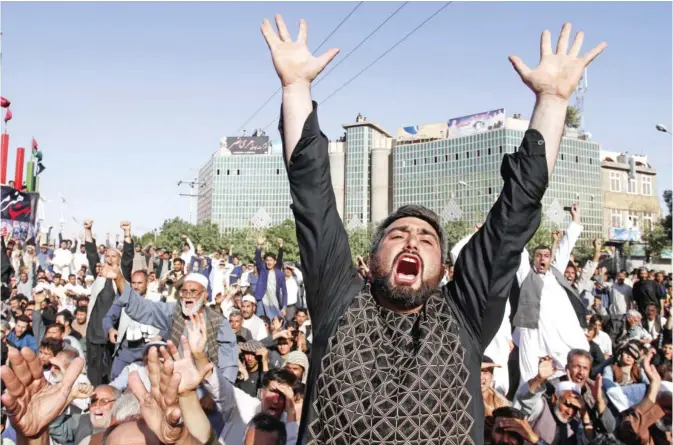  ??  ?? HERAT: Protesters shout slogans during a demonstrat­ion in western Herat province of Afghanista­n. — AP