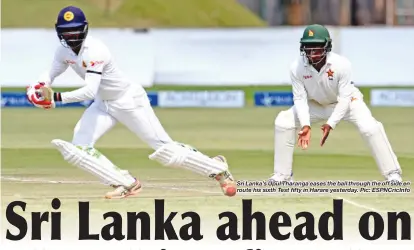  ??  ?? Sri Lanka’s Upul Tharanga eases the ball through the off side en route his sixth Test fifty in Harare yesterday. Pic: ESPNCricIn­fo