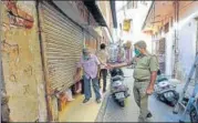  ?? HT/PTI ?? Policemen cracking down on a lockdown violator in Udaiganj and (right) a cop urging a shopkeeper to close his shop during the lockdown, in another area of Lucknow, on Wednesday.