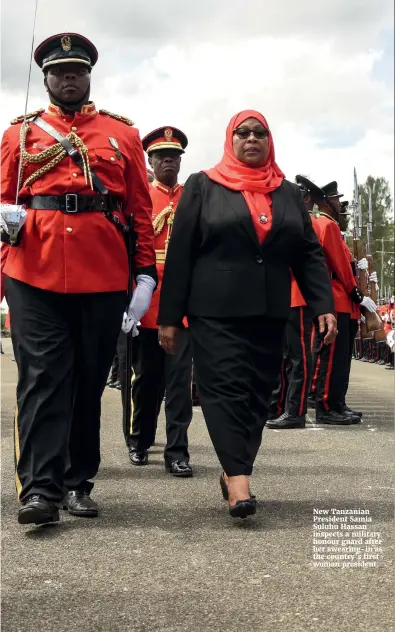  ??  ?? New Tanzanian President Samia Suluhu Hassan inspects a military honour guard after her swearing-in as the country’s first woman president.
