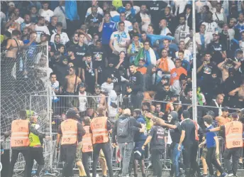  ?? — AFP photo ?? Marseille’s supporters invade the field after the French L1 match between Angers and Marseille, at Raymond-Kopa stadium in Angers, in this Sept 22 file photo.