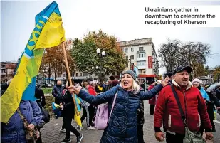  ?? ?? Ukrainians gather in downtown to celebrate the recapturin­g of Kherson