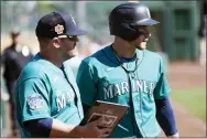  ?? ROSS D. FRANKLIN — THE ASSOCIATED PRESS ?? Seattle Mariners’ Jarred Kelenic, right, watches Chicago White Sox relief pitcher Reynaldo Lopez with Mariners hitting coach Tony Arnerich during the third inning of a spring training baseball game Monday, Feb. 27, 2023, in Phoenix.