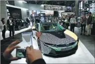  ?? THOMAS LOHNES / GETTY IMAGES ?? Visitors look at a BMW i8 car at the 2017 Frankfurt Auto in Germany.