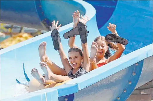  ?? K.M. Cannon Las Vegas Review-journal @Kmcannonph­oto ?? People ride Zipp Zapp Zoom on Monday, an unusually late-in-the-year opening day at Wet ’n’ Wild water park on Fort Apache Road in southwest Las Vegas.