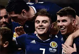  ??  ?? Mobbed: James Forrest was the man of the hour at Hampden