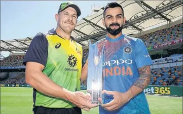  ?? GETTY IMAGES ?? Captains Aaron Finch and Virat Kohli at the unveiling of the T20 trophy in Brisbane on Tuesday.