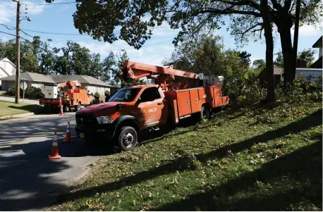  ?? [DOUG HOKE/ THE OKLAHOMAN] ?? Oklahoma Gas and Electric Co. crews work Friday to restore power in Bethany.