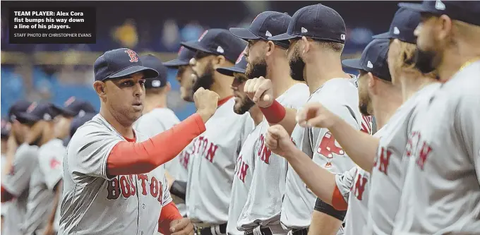  ?? STAFF PHOTO BY CHRISTOPHE­R EVANS ?? TEAM PLAYER: Alex Cora fist bumps his way down a line of his players.