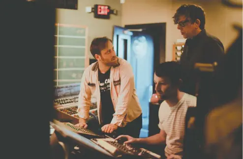  ?? PHOTOS: ALYSSE GAFKJEN ?? The Black Keys — Dan Auerbach, left, and Patrick Carney, behind right — are seen hard at work in a Nashville studio in 2019.