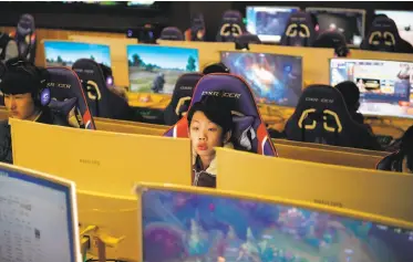  ?? Greg Baker / AFP / Getty Images ?? A student uses a computer in an e-sports class at the Lanxiang technical school in Jinan, China. The government has unveiled plans to control the number of online games as part of an effort to cut myopia.