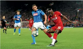  ??  ?? Liverpool striker Sadio Mane, right, takes on Napoli’s Allan during their Champions League clash at Anfield.