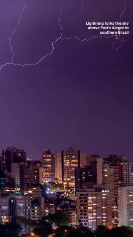  ??  ?? Lightning forks the sky above Porto Alegre in southern Brazil