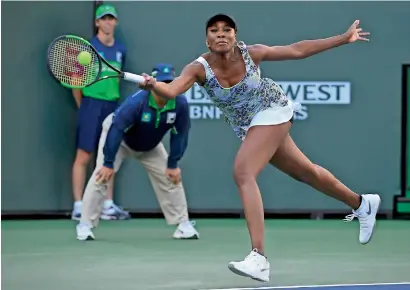  ??  ?? Venus Williams returns a shot against Carla Suarez Navarro during the quarterfin­als at the BNP Paribas Open.