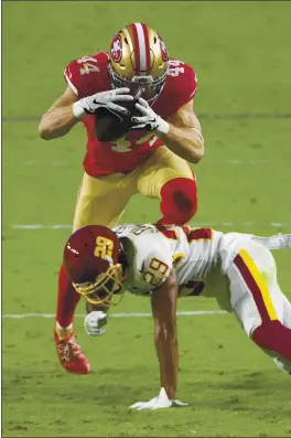  ?? JENNIFER STEWART – THE ASSOCIATED PRESS ?? Fullback Kyle Juszczyk of the 49ers jumps over Washington Football Team cornerback Kendall Fuller en route to a fourth- quarter touchdown during Sunday’s game.