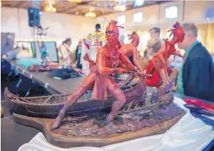  ?? EDDIE MOORE/JOURNAL ?? Ed Natiya, Navajo, from Albuquerqu­e, won best sculpture with this depiction of Iroquois warriors at the 95th Santa Fe Indian Market Best of Show Awards Ceremony on Friday.