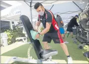  ?? DOUGLAS ZIMMERMAN — SPECIAL TO THE MARIN INDEPENDEN­T JOURNAL ?? Lee Boyajian, a trainer at Rolling Hills Country Club in Novato, disinfects equipment at the outdoor workout area in July.