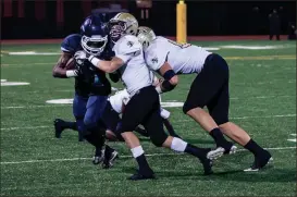  ?? TIM GODBEE / For the Calhoun Times ?? Calhoun’s Tripp Hoblitzell (center) and Davis Allen (right) combine to bring down a Cedar Grove player during last Friday’s game.