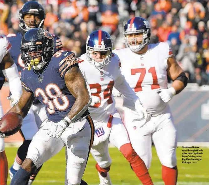  ?? GETTY ?? Tashaun Gipson runs through Giants after intercepti­on in Bears’ victory over Big Blue Sunday in Chicago.