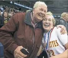  ?? Steph Chambers/Post-Gazette ?? Tess Myers celebrates with her grandfathe­r, Joe Myers, after she hit the winning shot for Cardinal Wuerl North Catholic in a WPIAL championsh­ip.