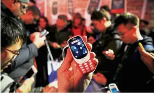  ??  ?? New look: An enthusiast taking a closer look at the new Nokia 3310 at a mobile expo in Barcelona. — Reuters