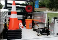  ?? Diane Wagner / Rome News-Tribune ?? Among the standard equipment on an F-250 CHAMP pickup truck parked Monday at the Cartersvil­le GDOT office are traffic cones, a shovel and sledge hammer, jumper cables and tools, a small amount of emergency fuel, oil-dry to soak up spills, an air...