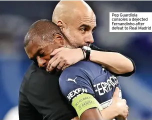  ?? ?? Pep Guardiola consoles a dejected Fernandinh­o after defeat to Real Madrid