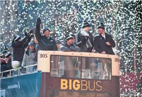  ??  ?? Philadelph­ia Eagles players and owner Jeffrey Lurie ride a float during the Super Bowl LII victory parade Thursday. CHRIS LACHALL/COURIER-POST (CHERRY HILL, N.J.)