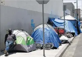  ?? Genaro Molina Los Angeles Times ?? JAMES EARL Davis sits on skid row last summer. A panel charged with directing homeless funds faces a May 10 deadline for sending a budget to county officials.